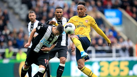 Arsenal's Pierre-Emerick Aubameyang, right, and Newcastle United's Javier Manquillo battle for the ball during the English Premier League soccer match between Newcastle United and Arsenal, at St James' Park, in Newcastle, England, Sunday, Aug. 11, 2019.