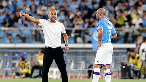 Manchester City's manager Pep Guardiola, left, gestures to Kyle Walker during their friendly soccer match against Yokohama F Marinos in Yokohama, Japan, Saturday, July 27, 2019. (AP Photo/Shuji Kajiyama)