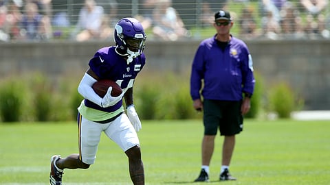 Minnesota Vikings wide receiver Stefon Diggs, left, runs a pass play as head coach Mike Zimmer watches during the NFL football team's training camp on July 29, 2019.