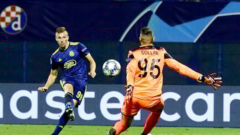 Dinamo Zagreb's Mislav Orsic, left, scores a goal against Atalanta during the group C Champions League soccer match between Dinamo Zagreb and Atalanta at the Maksimir Stadium in Zagreb, Croatia, Wednesday, Sept. 18, 2019.