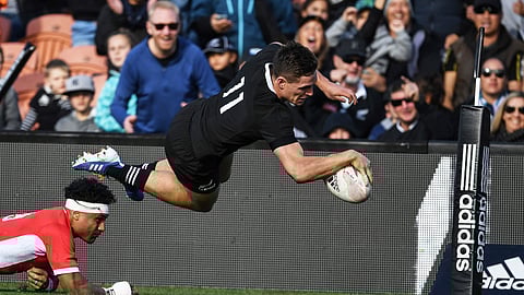 New Zealand's George Bridge is airborne as he dives across the line to score a try against Tonga during their rugby test match in Hamilton, New Zealand, Saturday, Sept. 7, 2019. The All Blacks defeated Tonga 92-7. (Andrew Cornaga/Photosport via AP)