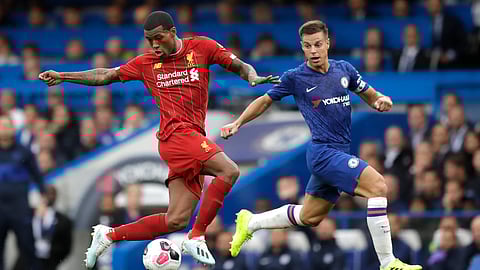 Liverpool's Georginio Wijnaldum, left, and Chelsea's Cesar Azpilicueta compete for the ball during the British premier League soccer match between Chelsea and Liverpool, at the Stamford Bridge Stadium, London, Sunday, Sept. 22, 2019. (AP Photo/Matt Dunham)