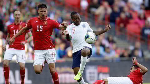 Bulgaria's Georgi Sarmov, right, tackles England's Raheem Sterling during the Euro 2020 group A qualifying soccer match between England and Bulgaria at Wembley stadium in London, Saturday, Sept. 7, 2019.