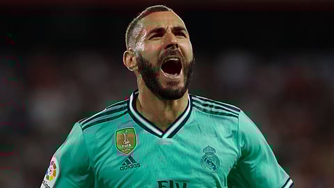 Real Madrid's Karim Benzema celebrates after scoring his side's opening goal during the Spanish La Liga soccer match between Sevilla and Real Madrid at the Ramon Sanchez Pizjuan stadium in Seville, Spain, Sunday, Sept. 22, 2019. (AP Photo/Miguel Morenatti)