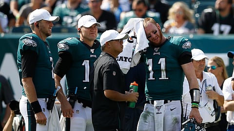Philadelphia Eagles' Carson Wentz (11) wipes his face during the first half of an NFL football game against the Detroit Lions, Sunday, Sept. 22, 2019, in Philadelphia.