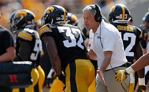 Iowa head coach Kirk Ferentz (right) talks with linebacker Djimon Colbert after a play against Rutgers on Sept. 7 (Matthew Putney)