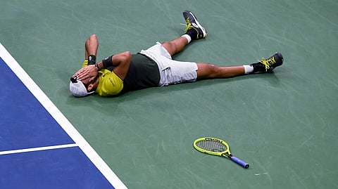 Matteo Berrettini, of Italy, falls to the court after winning the fifth set tie break for victory against Gael Monfils, of France, during the quarterfinals of the U.S. Open tennis championships Wednesday, Sept. 4, 2019, in New York. (AP Photo/Sarah Stier)