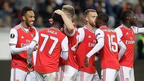 Arsenal's Pierre-Emerick Aubameyang, left, celebrates after scoring his side's third goal during the Europa League Group F soccer match between Eintracht Frankfurt and Arsenal in the Commerzbank Arena in Frankfurt, Germany, Thursday, Sept. 19, 2019. (AP Photo/Michael Probst)
