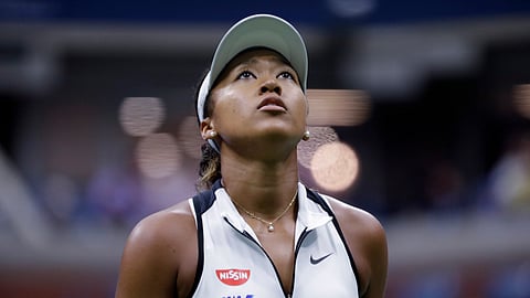 Naomi Osaka, of Japan, looks up at the score board during her match against Belinda Bencic, of Switzerland, in the fourth round of the US Open tennis championships Monday, Sept. 2, 2019, in New York.