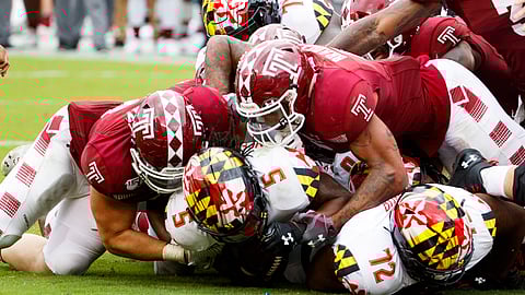Maryland running back Anthony McFarland Jr. (5) is stopped short of the goal line by Temple defensive end Zack Mesday, left, and linebacker Shaun Bradley, right, during the second half of an NCAA college football, Saturday, Sept. 14, 2019, in Philadelphia. Temple won 20-17. (AP Photo/Chris Szagola)