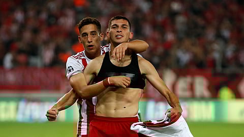 In this August 2019 file photo, Olympiakos' Lazar Randelovic, right, celebrates after scoring his side's third goal during the Champions League qualifying playoff first leg soccer match between Olympiakos and Krasnodar at Georgios Karaiskakis stadium in Piraeus port.