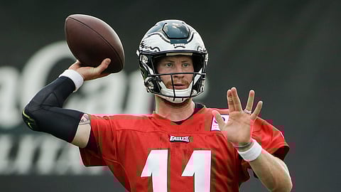 FILE - In this July 25, 2019, file photo, Philadelphia Eagles quarterback Carson Wentz throws a pass during practice at the NFL football team's training camp in Philadelphia. Wentz, Jason Peters and Darren Sproles have unfinished business. The franchise quarterback, the nine-time Pro Bowl left tackle and the versatile veteran were injured when the Eagles won the first Super Bowl in franchise history following the 2017 season. They are determined to deliver another parade down Broad Street. (AP Photo/Matt Rourke, File)