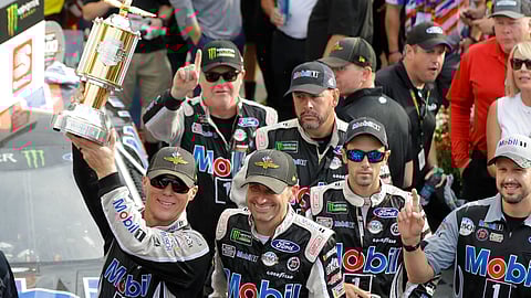 Kevin Harvick, left, celebrates after winning the NASCAR Brickyard 400 auto race at Indianapolis Motor Speedway, Sunday, Sept. 8, 2019, in Indianapolis. (AP Photo/Darron Cummings)