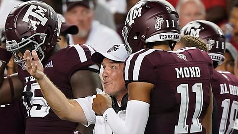 Texas A&M head coach Jimbo Fisher reacts after Texas A&M quarterback Kellen Mond (11) returns to the sideline after throwing an interception against Lamar during the second half of an NCAA college football game, Saturday, Sept. 14, 2019, in College Station, Texas. (AP Photo/Sam Craft)