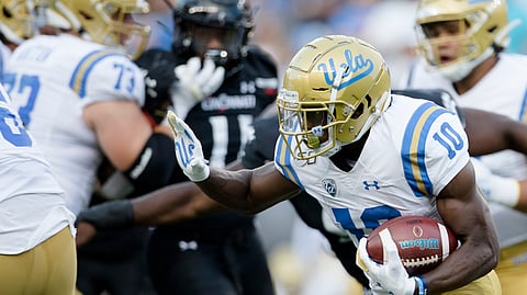 UCLA wide receiver Demetric Felton (10) runs with the ball against Cincinnati during the first half of an NCAA college football game Thursday, Aug. 29, 2019, in Cincinnati. (Albert Cesare/The Cincinnati Enquirer via AP)