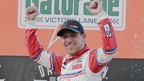 Denny Hamlin celebrates in Victory Lane after winning a NASCAR Xfinity Series auto race on Saturday, Aug. 31, 2019, at Darlington Raceway in Darlington, S.C. Hamlin was stripped of his win after he failed post-race inspection. Cole Custer was declared the winner. (AP Photo/Terry Renna)