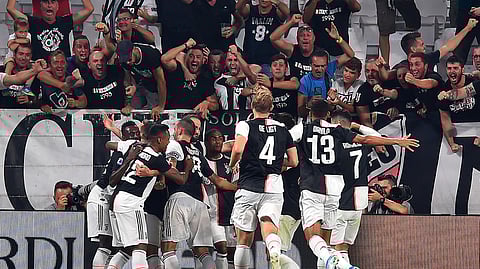 Juventus' Gonzalo Higuain, center left, celebrates scoring with his teammates during the Italian Serie A soccer match Juventus FC and SSC Napoli at the Allianz Stadium in Turin, Italy, Saturday Aug. 31, 2019. (Alessandro di Marco/ANSA via AP)