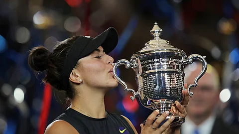 Bianca Andreescu, of Canada, kisses the championship trophy after defeating Serena Williams, of the United States, in the women's singles final of the U.S. Open tennis championships Saturday, Sept. 7, 2019, in New York. (AP Photo/Charles Krupa)