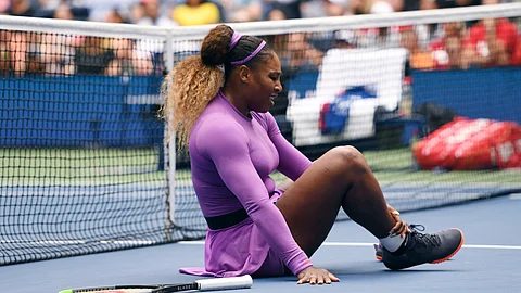 Serena Williams, of the United States, grabs her ankle after falling while chasing a return against Petra Martic, of Croatia, during round four of the US Open tennis championships Sunday, Sept. 1, 2019, in New York. (AP Photo/Sarah Stier)