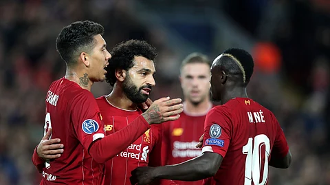Liverpool's Mohamed Salah, second left, celebrates with teammates after scoring his side's third goal during the Champions League group E soccer match between Liverpool and Red Bull Salzburg at Anfield stadium in Liverpool, England, Wednesday, Oct. 2, 2019. (AP Photo/Jon Super)