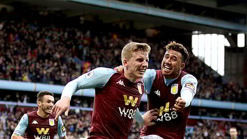 Aston Villa's Matt Targett, left, celebrates scoring his side's second goal, during the Premier League soccer match between Aston Villa and Brighton and Hove Albion, at Villa Park, Birmingham, England, Saturday, Oct. 19, 2019. (Nick Potts/PA via AP)
