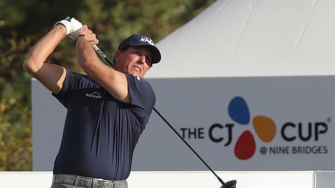 Phil Mickelson of the United States watches his shot on the 10th hole during the first round of the CJ Cup PGA golf tournament at Nine Bridges on Jeju Island, South Korea, Thursday, Oct. 17, 2019. In China this week, Mickelson is trying to finish in the Top 50 for the 26th straight year. (Park Ji-ho/Yonhap via AP)