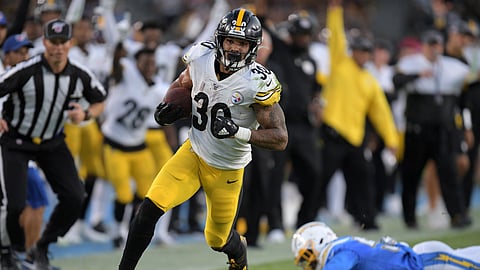 Pittsburgh Steelers running back James Conner, left, gets by Los Angeles Chargers outside linebacker Jatavis Brown as he runs for a touchdown during the first half of an NFL football game, Sunday, Oct. 13, 2019, in Carson, California.
