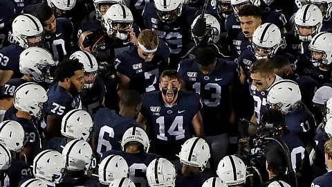 Penn State quarterback Sean Clifford (14) fires up teammates before an NCAA college football game against Michigan in State College, Pa., Saturday, Oct. 19, 2019. (AP Photo/Gene J. Puskar)