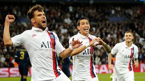 PSG's Angel Di Maria, center, celebrates with his teammates PSG's Juan Bernat, left, and PSG's Mauro Icardi after scoring his side's opening goal during the Champions League group A soccer match between PSG and Real Madrid at the Parc des Princes stadium in Paris, Wednesday, Sept. 18, 2019.