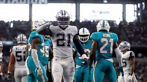 Dallas Cowboys running back Ezekiel Elliott (21) celebrates his run for a first down in the second half of an NFL football game against the Miami Dolphins in Arlington, Texas, Sunday, Sept. 22, 2019. (AP Photo/Ron Jenkins)