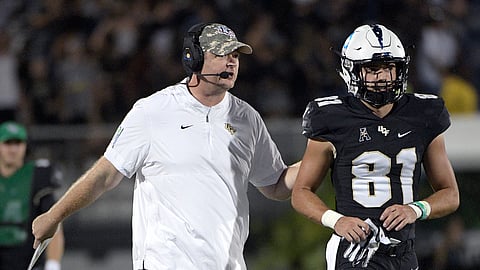 Central Florida head coach Josh Heupel, left, gives instructions to wide receiver Alex Harris (81) during the first half of an NCAA college football game against Connecticut, Saturday, Sept. 28, 2019, in Orlando, Fla. (AP Photo/Phelan M. Ebenhack)