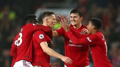 Manchester United players celebrate after Manchester United's Scott McTominay, centre, scored his side's opening goal during the English Premier League soccer match between Manchester United and Arsenal at Old Trafford in Manchester, England, Monday, Sept. 30, 2019.