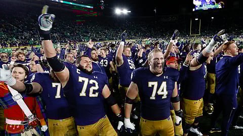 Notre Dame offensive linemen Robert Hainsey (72) and Liam Eichenberg (74) celebrate after defeating Southern California in an NCAA college football game in South Bend, Ind., Saturday, Oct. 12, 2019. (AP Photo/Paul Sancya)