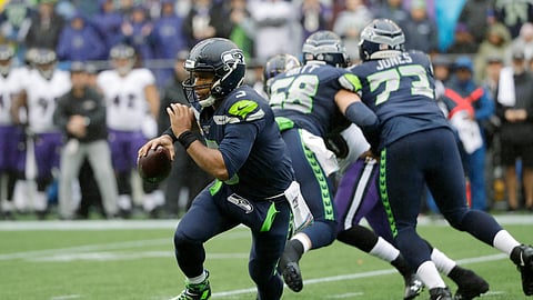 Seattle Seahawks quarterback Russell Wilson scrambles during the first half of an NFL football game against the Baltimore Ravens, Sunday, Oct. 20, 2019, in Seattle.