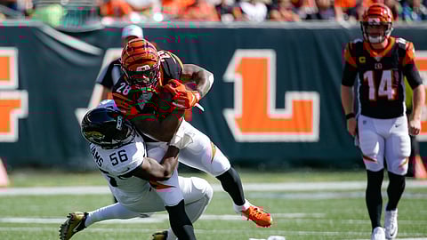 Cincinnati Bengals running back Joe Mixon (28) is tackled by Jacksonville Jaguars linebacker Quincy Williams (56) in the first half of an NFL football game, Sunday, Oct. 20, 2019, in Cincinnati. (AP Photo/Frank Victores)