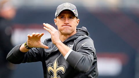 FILE - In this Sunday, Oct. 20, 2019, file photo, New Orleans Saints quarterback Drew Brees (9) works on his throwing motion before NFL football game against the Chicago Bears in Chicago,. Brees says he is comfortable throwing an NFL ball now that he is more than five weeks out of surgery on his right thumb. He says he plans to play Sunday against Arizona unless his form in practice this week does not meet his expectations. (AP Photo/Charles Rex Arbogast)