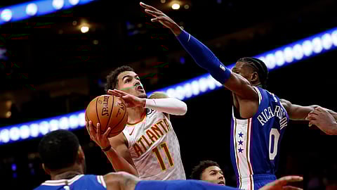 Atlanta Hawks guard Trae Young (11) goes up to shoot as Philadelphia 76ers guard Josh Richardson (0) defends in the first half of an NBA basketball game Monday, Oct. 28, 2019, in Atlanta. (AP Photo/John Bazemore)