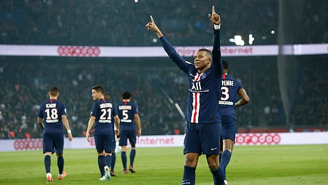 PSG's Kylian Mbappe celebrates after scoring his side goal during the French League One soccer match between PSG and Marseille at the Parc des Princes stadium in Paris, France, Sunday, Oct. 27, 2019.