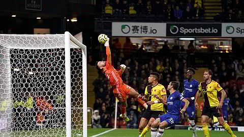 Watford goalkeeper Ben Foster saves a shot on goal from Chelsea's Tammy Abraham, second right, during the English Premiership League soccer match at Vicarage Road, Watford, England, Saturday Nov. 2, 2019.
