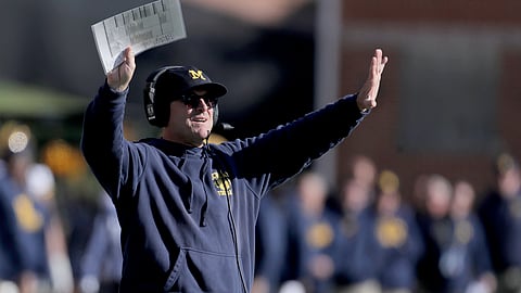 Michigan head coach Jim Harbaugh gestures toward his team during the second half of an NCAA college football game against Maryland, Saturday, Nov. 2, 2019, in College Park, Maryland.