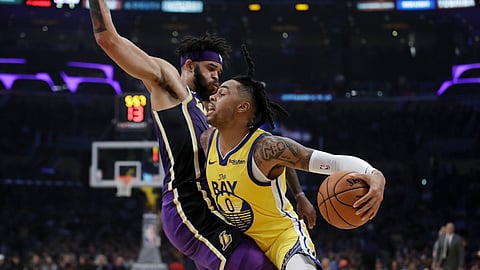 Golden State Warriors' D'Angelo Russell (0) is defended by Los Angeles Lakers' JaVale McGee during the first half of an NBA basketball game Wednesday, Nov. 13, 2019, in Los Angeles.