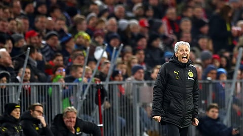 Dortmund's head coach Lucien Favre gives instructions to his players during the German Bundesliga soccer match between FC Bayern Munich and Borussia Dortmund, in Munich, Germany, Saturday, Nov. 9, 2019.