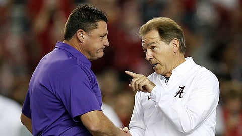 FILE - In this Nov. 4, 2017, file photo, LSU head coach Ed Orgeron, left, and Alabama head coach Nick Saban meet in the center of the field before an NCAA college football game, in Tuscaloosa, Ala. For the first time in college football history, there will be two games matching teams of at least 8-0 on the same day, according to ESPN Facts and Info. In Tuscaloosa, Alabama, LSU and the Crimson Tide will play the first regular-season game matching AP Nos. 1 and 2 since 2011 _ when No. 1 LSU beat No. 2 Alabama 9-6 in overtime. (AP Photo/Brynn Anderson, File)