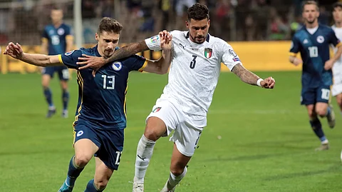 Italy's Emerson, right, duels for the ball with Bosnia's Gojko Cimirot during the Euro 2020 group J qualifying soccer match between Bosnia-Herzegovina and Italy at the Bilino polje stadium in Zenica, Bosnia, Friday, Nov. 15, 2019.