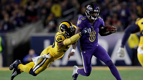 Baltimore Ravens quarterback Lamar Jackson, right, is tackled by Los Angeles Rams defensive end Dante Fowler during the second half of an NFL football game Monday, Nov. 25, 2019, in Los Angeles. (AP Photo/Marcio Jose Sanchez)