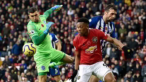 Brighton's goalkeeper Mathew Ryan, left, makes a save in front of Manchester United's Anthony Martial during the English Premier League soccer match between Manchester United and Brighton and Hove Albion, at the Old Trafford stadium in Manchester, England, Sunday, Nov. 10, 2019.