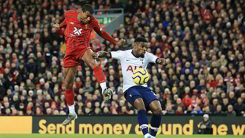 Liverpool's Georginio Wijnaldum, left, challenges for the ball with Tottenham's Serge Aurier during the English Premier League soccer match between Liverpool and Tottenham Hotspur at Anfield stadium in Liverpool, England, Sunday, Oct. 27, 2019.