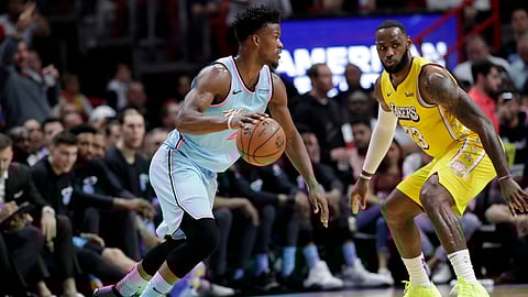 Miami Heat forward Jimmy Butler, left, drives to the basket as Los Angeles Lakers forward LeBron James (23) defends during the first half of an NBA basketball game, Friday, Dec. 13, 2019, in Miami. (AP Photo/Lynne Sladky)