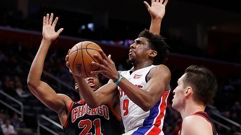 Detroit Pistons guard Langston Galloway (9) goes up for a layup as Chicago Bulls forward Thaddeus Young (21) defends during the first half of an NBA basketball game, Saturday, Dec. 21, 2019, in Detroit. (AP Photo/Carlos Osorio)
