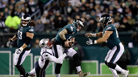 New England Patriots' Kyle Van Noy (53) tackles Philadelphia Eagles' Carson Wentz (11) during the first half of an NFL football game, Sunday, Nov. 17, 2019, in Philadelphia.